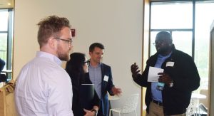 Student Patrick Njenga speaks with IAP members about his research