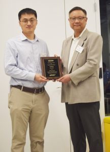 Yi Zhang (left) receives the Director's Award from Mu-Ping Nieh (right)